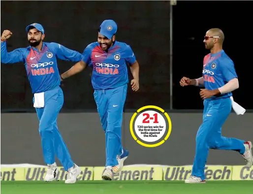  ?? PTI ?? T20 series win for the first time for India against the Kiwis India’s Rohit Sharma (centre), celebrates with captain Virat Kohli (left) and Shikhar Dhawan after taking a catch to dismiss New Zealand’s Colin Munro (unseen) during their third Twenty20...