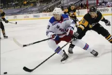  ??  ?? The Rangers’ Julien Gauthier and the Penguins’ Brian Dumoulin chase the puck in the second period.