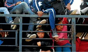  ?? AP ?? Central American migrants, part of the caravan hoping to reach the US border, get a ride on a truck, in Celaya, Mexico. Local Mexican officials helped thousands of Central American migrants find rides on the next leg of their journey toward the US border.