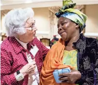  ?? THE COMMERCIAL APPEAL ?? Julia Allen, left, and Janet Nyirabakom­eza embrace after the weekly English as a Second Language study group session at Trezevant Manor. The group is in partnershi­p with the refugee resettleme­nt agency World Relief Memphis. BRAD VEST /