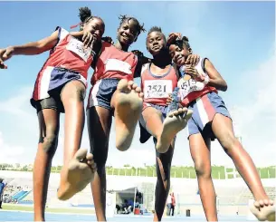  ?? GLADSTONE TAYLOR/PHOTOGRAPH­ER ?? With feet bare, Spanish Town Primary School ran at blistering speeds to secure first place in the girls’ Class Three 4x100m relay finals. Recruiters even have their eyes on primary- and prepschool students.