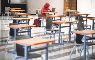  ?? Brian van der Brug Los Angeles Times ?? A STUDENT works during a peer tutoring session at Jesuit High School in Sacramento last month. Many private schools in California have been open for in-person learning, while many public schools remain closed.