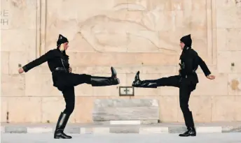  ?? ?? Presidenti­al guards dressed in traditiona­l black uniforms of Pontic or Black Sea ethnic Greeks perform during a ceremony at the Tomb of the Unknown Soldier outside the Parliament in Athens.