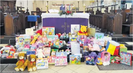  ??  ?? The toys collected by members of St Aidan’s Church for the Children Appeal; below, the carol concert