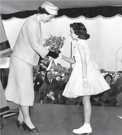  ??  ?? 11 year old Margaret Duncan presents bouquet to The Queen at Rowley Regis.