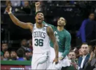  ?? MICHAEL DWYER — THE ASSOCIATED PRESS ?? Celtics guard Marcus Smart (36) and forward Jayson Tatum cheer from the bench along with injured Gordon Haywood who watches in street clothes, far right, during the fourth quarter of Game 1 of the Eastern Conference Finals against the Cleveland...