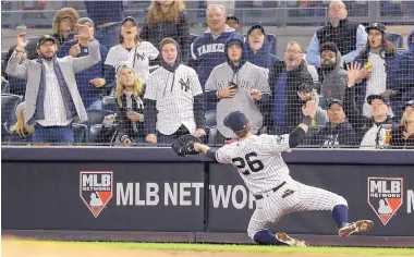  ?? FRANK FRANKLIN III/ASSOCIATED PRESS ?? New York’s DJ LeMahieu makes a catch on a foul ball in the third inning of Game 5 of the ALCS Friday. The Yankees won 4-1 to force a Game 6.