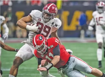  ?? GEORGIA PHOTO/DAVID WEIKEL ?? Alabama defensive end Raekwon Davis tries to avoid a hit from Georgia quarterbac­k Jake Fromm during an intercepti­on return in the Crimson Tide’s 26-23 overtime win against the Bulldogs in January at Atlanta’s Mercedes-Benz Stadium. The same two teams that played for last season’s national championsh­ip will square off this week for the Southeaste­rn Conference title.