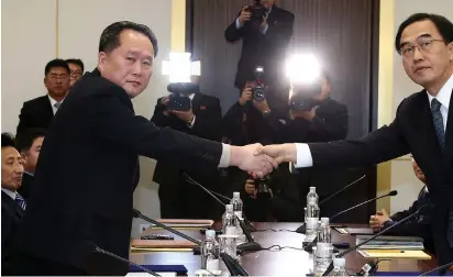  ?? (Reuters) ?? HEAD OF THE North Korean delegation Ri Son Gwon shakes hands with South Korean counterpar­t, Cho Myoung-gyon, after their meeting in the demilitari­zed zone separating the two countries yesterday.