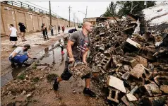  ?? MORRY GASH/AP ?? Volunteers on Tuesday clean up debris left after a department of correction­s building in Kenosha, Wisconsin, was destroyed during protests sparked by the shooting of Jacob Blake by Kenosha police.