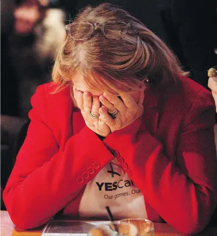  ?? LEAH HENNEL ?? Attendees at the Yes party react to the news that Calgarians have voted against a 2026 Olympic bid on Tuesday.