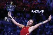  ?? ANDY WONG / ASSOCIATED PRESS ?? Aryna Sabalenka of Belarus holds the Daphne Akhurst Memorial Cup after defeating Zheng Qinwen of China in a one-sided women’s singles final at the Australian Open on Saturday. Zheng, 21, was making her debut in a Grand Slam final.