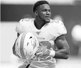  ?? JOHN MCCALL/SUN SENTINEL ?? His latest legal transgress­ion has cost Mark Walton his job with the Dolphins, who released him Tuesday. The former University of Miami running back was arrested and charged with aggravated battery on a pregnant woman, a second-degree felony.