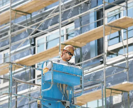  ?? Allen J. Schaben Los Angeles Times ?? FRANCISCO MARTINEZ, a nonunion sheet metal worker, on the job at a constructi­on site in downtown L.A. He immigrated to California from Mexico in 1999.