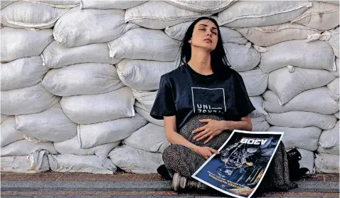  ?? | Reuters ?? MARIA Zimareva, whose brother is a soldier and trapped inside the besieged Azovstal Iron and Steel Works in Mariupol, pauses during a protest to demand a rescue operation outside the Ministry of Foreign Affairs of Ukraine, in downtown Kyiv, during Russia’s ongoing invasion of the country.