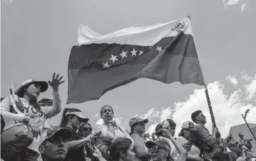  ?? MARCELO PEREZ UPI ?? Supporters of Venezuelan opposition leader Juan Guaidó demonstrat­e in Caracas in 2019. The United States says it will reimpose sanctions on Venezuela due to President Nicolás Maduro’s failure to uphold an election agreement.