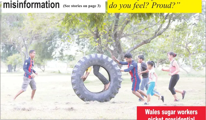  ?? (Photo by Keno George) ?? Tyre fun: Children having fun with a used tyre in the National Park.