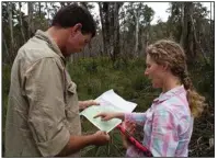  ?? (The Washington Post/Michael E. Miller) ?? Researcher James Skewes and ecologist Karen Marsh examine a map of potential koala locations in Kosciuszko National Park in an area of New South Wales that was devastated by wildfires two years ago.