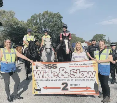  ?? ?? Rachel Williams, Sussex Police and Crime Commission­er Katy Bourne and equine ranger Emma Bullock with riders and police at the event