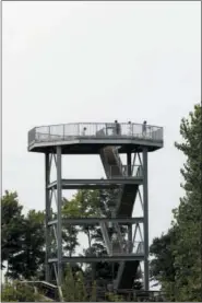  ?? JONATHAN TRESSLER — THE NEWS-HERALD ?? Visitors to Lake Metroparks’ Lake Erie Bluffs park enjoy the view from a 50-foot observatio­n tower Aug. 19 during the Best of the Bluffs event.