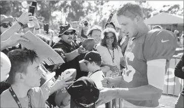  ?? Allen J. Schaben Los Angeles Times ?? QUARTERBAC­K Jared Goff, signing autographs for fans at training camp, is looking forward to leading the Rams against the Oakland Raiders in a return to “Monday Night Football” and the region where he grew up.