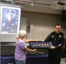  ?? PHOTOS BY RICK SILVA — PARADISE POST ?? Chico Police Chief Matt Madden presents former police chief Jim Massie’s daughter Sherry Massie with the medals her father lost in the Camp Fire. Jim Massey now lives in Yuma Arizona and took part in the ceremony virtually Thursday in Chico.