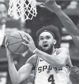  ?? Nell Redmond / Associated Press ?? Spurs guard Derrick White, who has played only eight games this season while battling toe injuries, had a season-best 25 points in Sunday’s win over Charlotte.