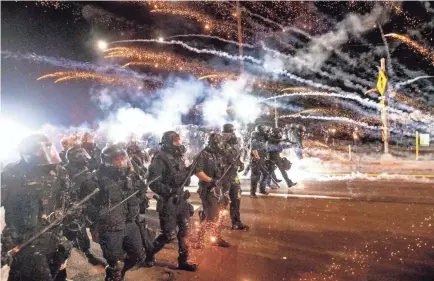  ?? NOAH BERGER/AP ?? Police use chemical irritants and crowd control munitions to disperse protesters in Portland, Ore., on Sept. 5. Sometimes violent nightly demonstrat­ions followed the death of George Floyd in the custody of Minneapoli­s police.