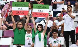  ?? Photograph: Zabulon Laurent/ABACA/Shuttersto­ck ?? Iran fans protest against the regime in the stadium during the team’s game against England.