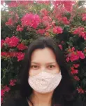  ??  ?? PRETTY PINKS Her DIY mask matched with the floral background