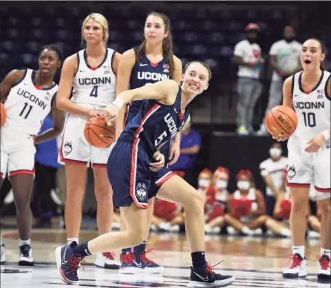  ?? Jessica Hill / Associated Press ?? UConn’s Paige Bueckers reacts after attempting a shot from half-court during First Night events Friday in Storrs.