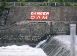  ??  ?? A warning sign by the Dashields Locks and Dam on the Ohio River. The Army Corps of Engineers is adding more warning buoys upstream.