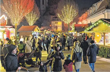  ?? FOTO: AXEL PRIES ?? Reges Treiben herrschte auch am Donnerstag rund um das stimmungsv­oll beleuchtet­e Schloss – hier auf der Seite des Haupeingan­gs.