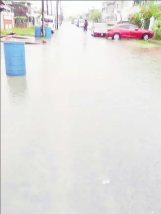  ?? ?? A flooded street in Alexander Village