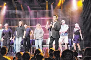  ?? Las Vegas Review-Journal file ?? Comic hypnotist Marc Savard, center, mocks volunteer guests at V Theater in Miracle Mile Shops at Planet Hollywood Resort in November 2013.