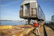  ?? TED SHAFFREY — THE ASSOCIATED PRESS ?? Donald Hutton, director of New York New Jersey Rail for the Port Authority of New York and New Jersey, describes how chains hold the subway train car on a flatcar on a railroad barge.