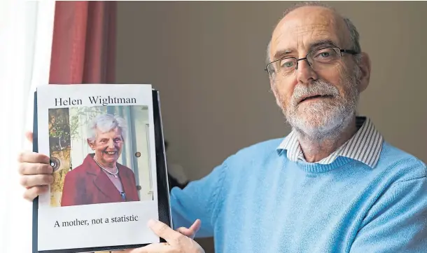  ??  ?? SEARCH FOR TRUTH: Alan Wightman holding a photo of his 88-year-old mother Helen who died after contractin­g coronaviru­s at a Fife care home.