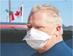  ?? Frank Gunn / the cana dian press ?? Ontario Premier Doug Ford leaves after picking up a load of ASTM Level 3 masks made by The Woodbridge Group
in Woodbridge, Ont., on Tuesday.