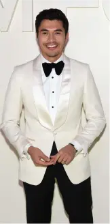  ??  ?? Henry Golding looks dapper in a white tuxedo