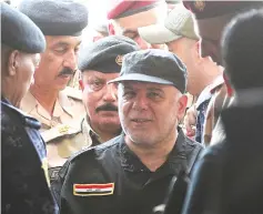  ?? — AFP photo ?? Abadi arrives in the al-Tayaran neighbourh­ood of Mosul to meet with military commanders after the government’s announceme­nt of the ‘liberation’ of the embattled city.
