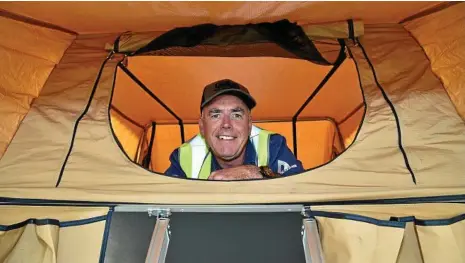  ?? PHOTO: BEV LACEY ?? COMFORTABL­E CAMPING: David Archer from ARB Toowoomba tests out this great tent ahead of the expo today.