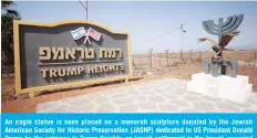  ??  ?? An eagle statue is seen placed on a menorah sculpture donated by the Jewish American Society for Historic Preservati­on (JASHP) dedicated to US President Donald Trump by the entrance to Trump Heights, an Israeli settlement in the Israeli-occupied Golan Heights on Sept 21, 2020. — AFP