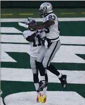  ?? BILL KOSTROUN – THE ASSOCIATED PRESS ?? Darren Waller, right, celebrates one of his two touchdowns and 13receptio­ns against the New York Jets on Sunday.