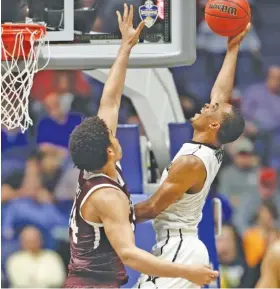  ?? THE ASSOCIATED PRESS ?? Vanderbilt guard Joe Toye drives to the basket against Texas A&M center Tyler Davis during the second half of their SEC tournament game Thursday in Nashville. Toye scored a careerhigh 18 points to help the Commodores win 66-41.