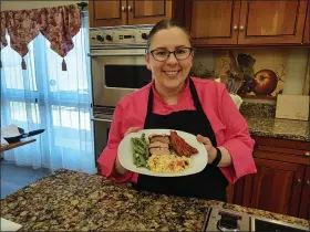  ?? SUBMITTED ?? Loretta Paganini School of Cooking instructor Kate Csepegi shows off a finished dinner created from a kit of ingredient­s and a YouTube video. Shown here are Orzo Pasta Salad and Spice Rubbed Pork Tenderloin with Green Beans and Sweet Potato Wedges.