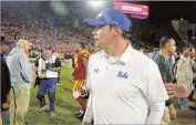  ?? Luis Sinco Los Angeles Times ?? JIM MORA walks off the field after UCLA’s 28-23 loss to crosstown rival USC on Saturday.