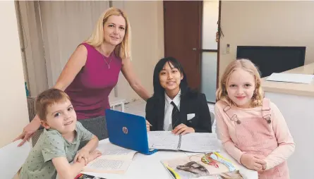  ?? ?? Melanie Duff with her children Austin, 7, and Emily, 8, and Japanese student Iroha Suzuki, 15, from Yokohama, who is staying with them at Highland Park as part of a homestay program. Picture: Glenn Hampson