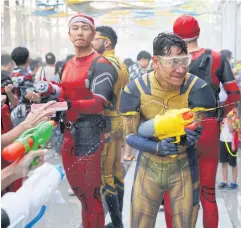  ?? VARUTH HIRUNYATHE­B ?? Young men don Ultraman suits yesterday as they celebrate Songkran festivitie­s at Samyan Mitrtown Songkran 2024 in Pathumwan district.