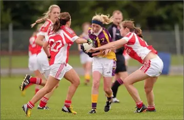  ??  ?? Kellie Kearney is outnumbere­d as she battles her way through the Louth defence during the All-Ireland Junior championsh­ip semi-final seven years ago.