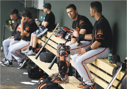  ?? Ralph Freso / Special to The Chronicle ?? Giants catcher Buster Posey (with shin guards, next to teammate Joe Panik) says occasional political conversati­ons among players have created no discord. Posey wants to expose his children to multiple political viewpoints.